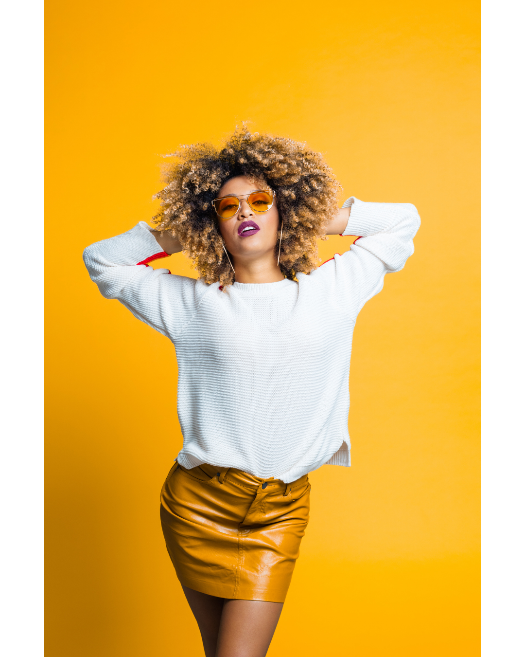 Fashion model wearing a beige dress sitting elegantly